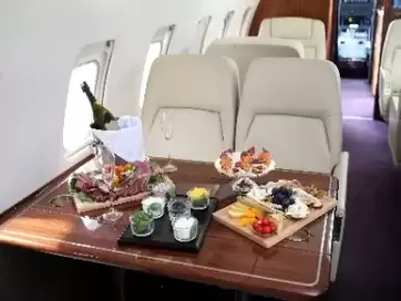Picture of fancy meal being served in first class on airplane