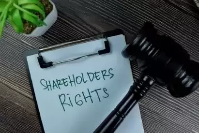 Concept of Shareholders Rights write on a paperwork isolated on Wooden Table.