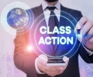 man holding glass plaque with both hands that says class action in a circle